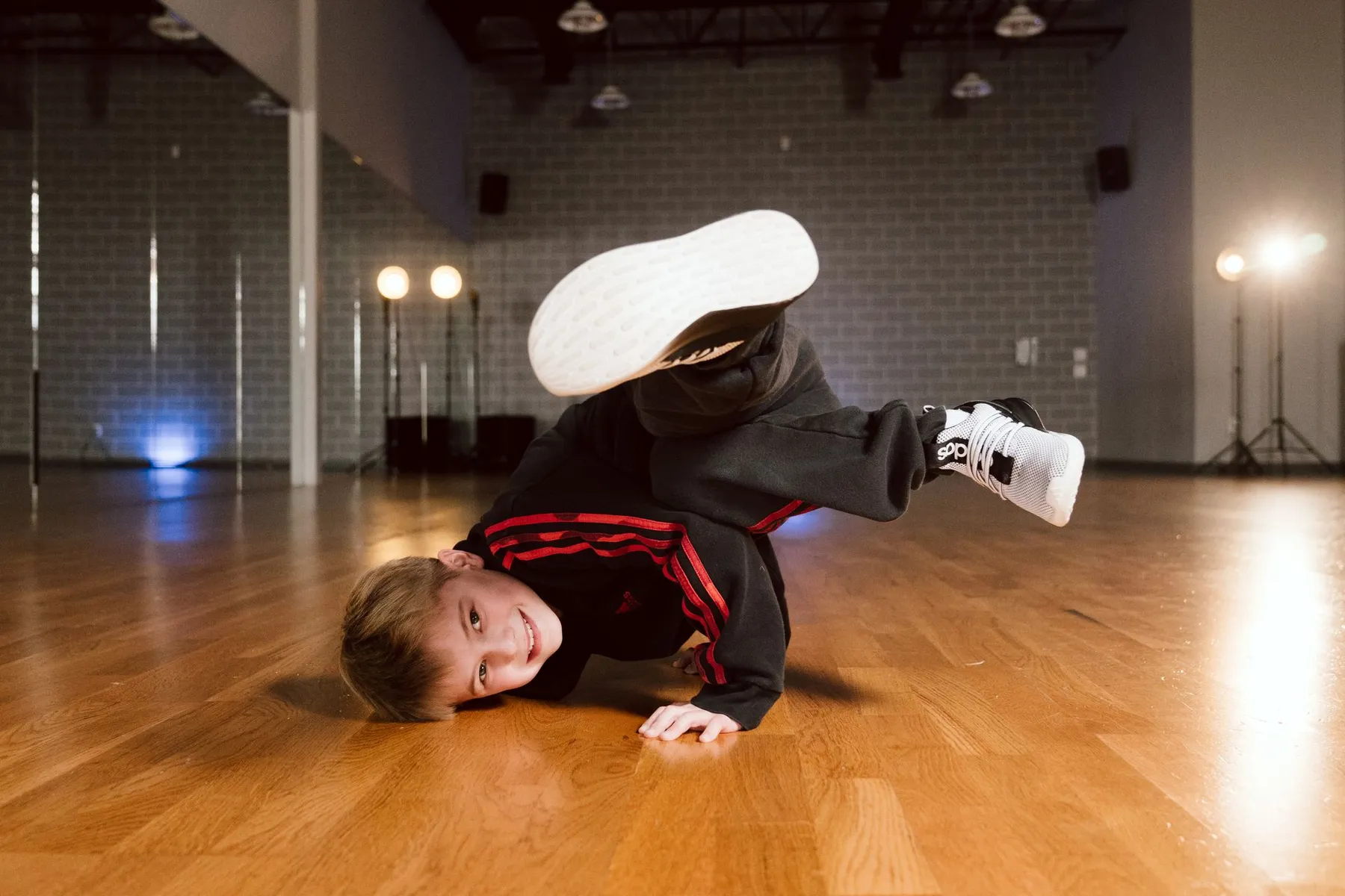 An ICON dancer holding a breakdance pose in the studio