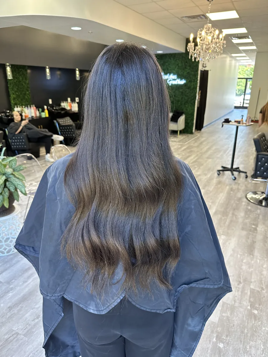 Long brunette lengths on the studio floor, the chandelier and stations behind
